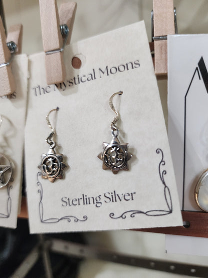 Sterling silver earrings featuring a radiant sun with the Om symbol at the center, displayed on a white background. Perfect for spiritual radiance, peace, and sacred style.