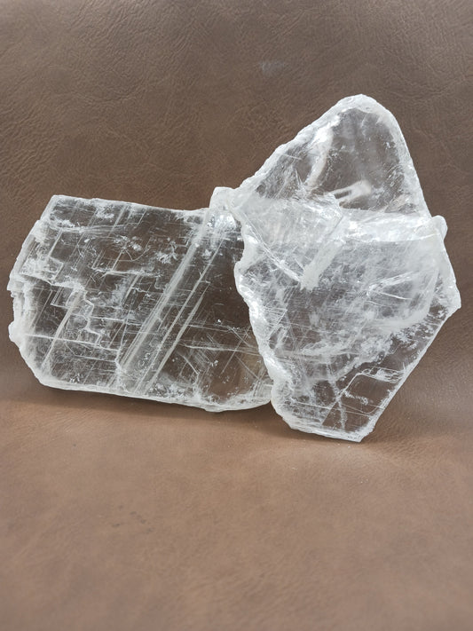 Pink selenite slab, polished with soft rosy hues, displayed on a white background.
