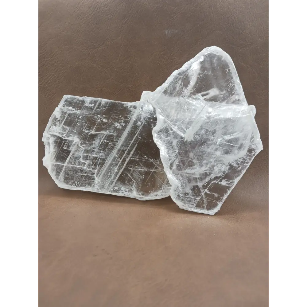 Pink selenite slab, polished with soft rosy hues, displayed on a white background.