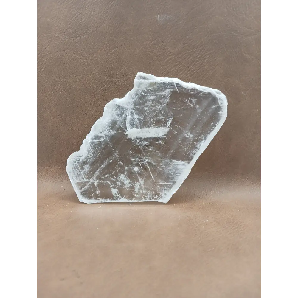 Pink selenite slab, polished with soft rosy hues, displayed on a white background.