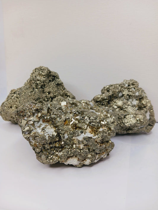 Gemmy Pyrite specimen with sparkling golden cubic crystals, displayed on a white background.