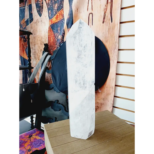 Diamantina clear quartz tower, 17 inches tall, polished with exceptional clarity and natural inclusions, displayed on a white background.