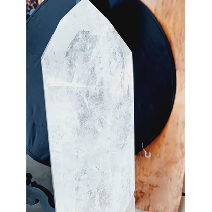 Diamantina clear quartz tower, 17 inches tall, polished with exceptional clarity and natural inclusions, displayed on a white background.