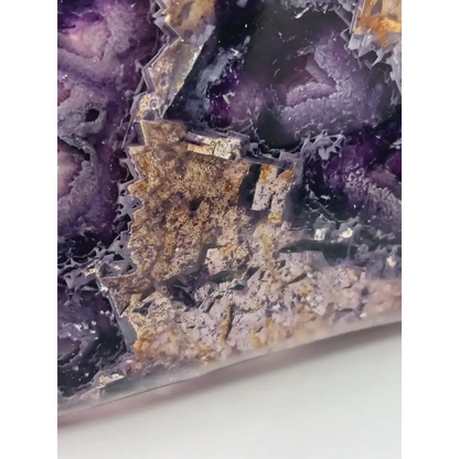 Rainbow fluorite bowl, 7.5 inches, with vibrant bands of color and a garden-like pattern on the back, displayed on a white background.