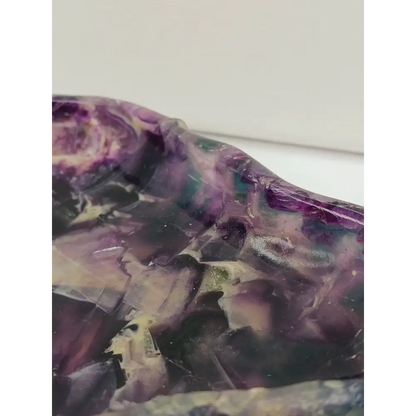 Rainbow fluorite bowl, 7.5 inches, with vibrant bands of color and a garden-like pattern on the back, displayed on a white background.
