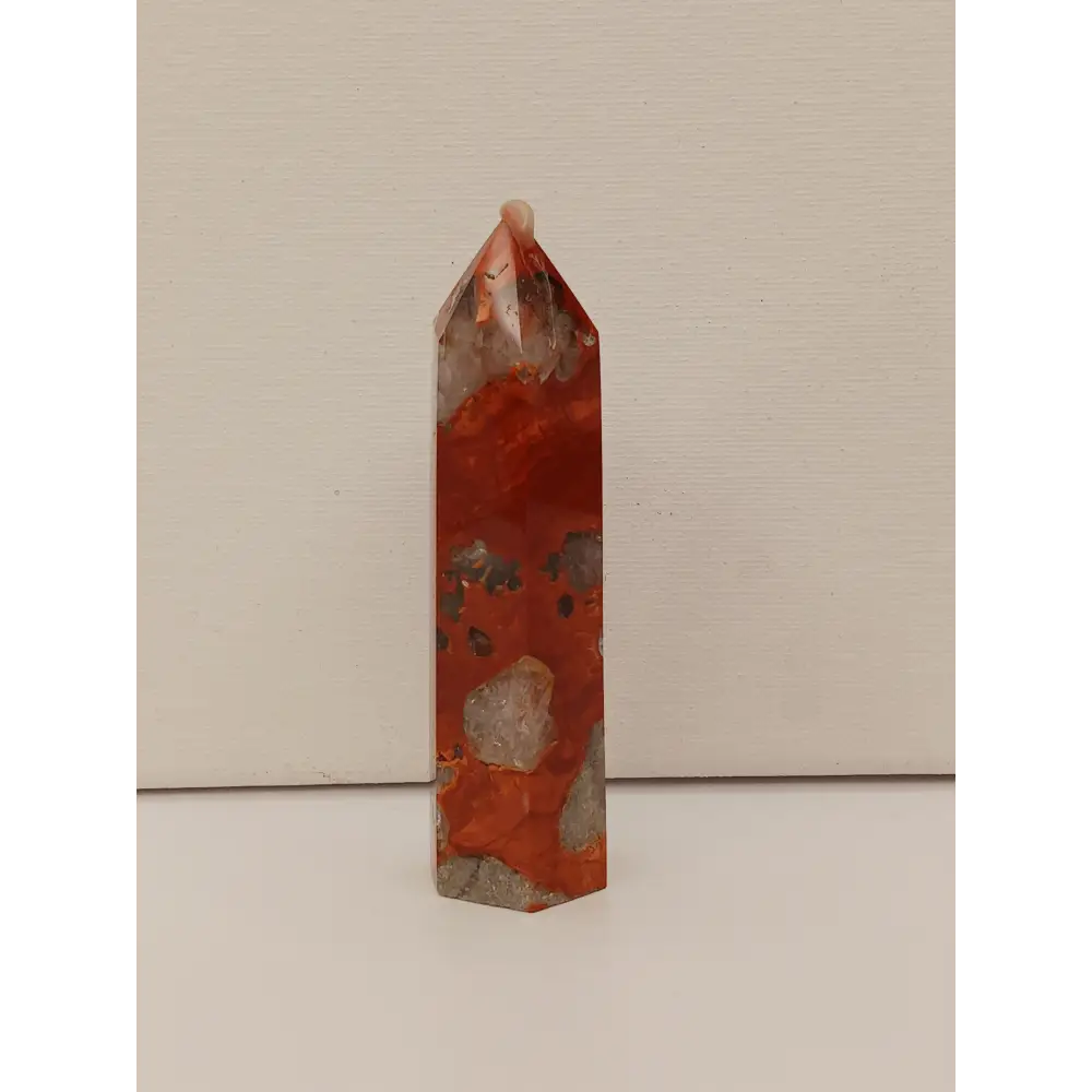 Hand-carved Red Jasper point with a clear quartz band, featuring vibrant red tones and a striking clear quartz stripe, displayed on a white background.