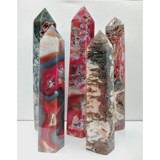 Set of three multicolored crystal sticks on a white background