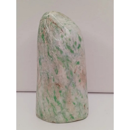 Sausserite freeform with soothing green hues and a unique, polished shape, displayed on a white background.