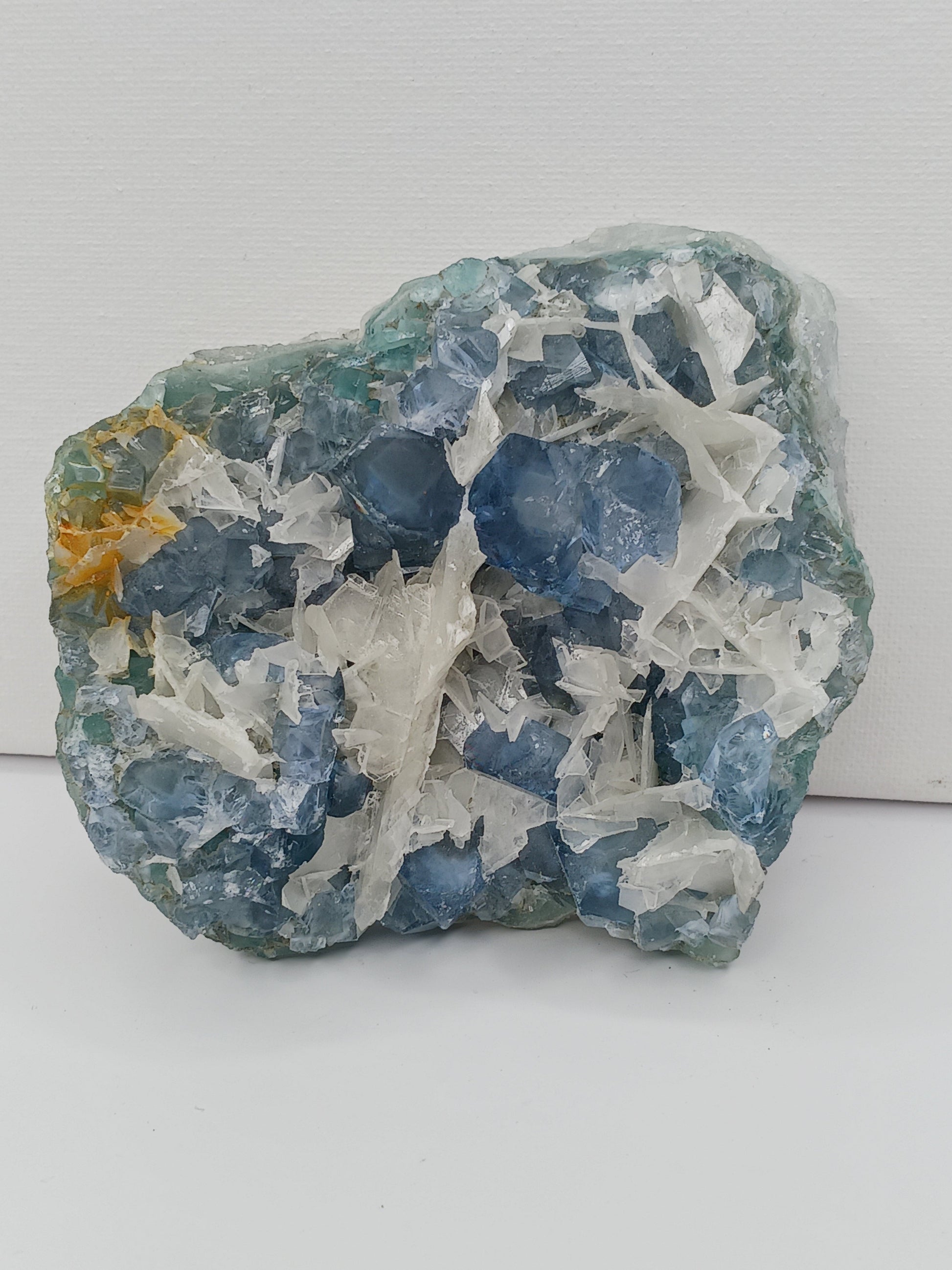 Sky blue fluorite with creamy calcite specimen, 4 x 5 inches, featuring unique blue and white patterns, displayed on a white background.