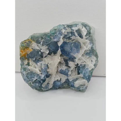 Sky blue fluorite with creamy calcite specimen, 4 x 5 inches, featuring unique blue and white patterns, displayed on a white background.