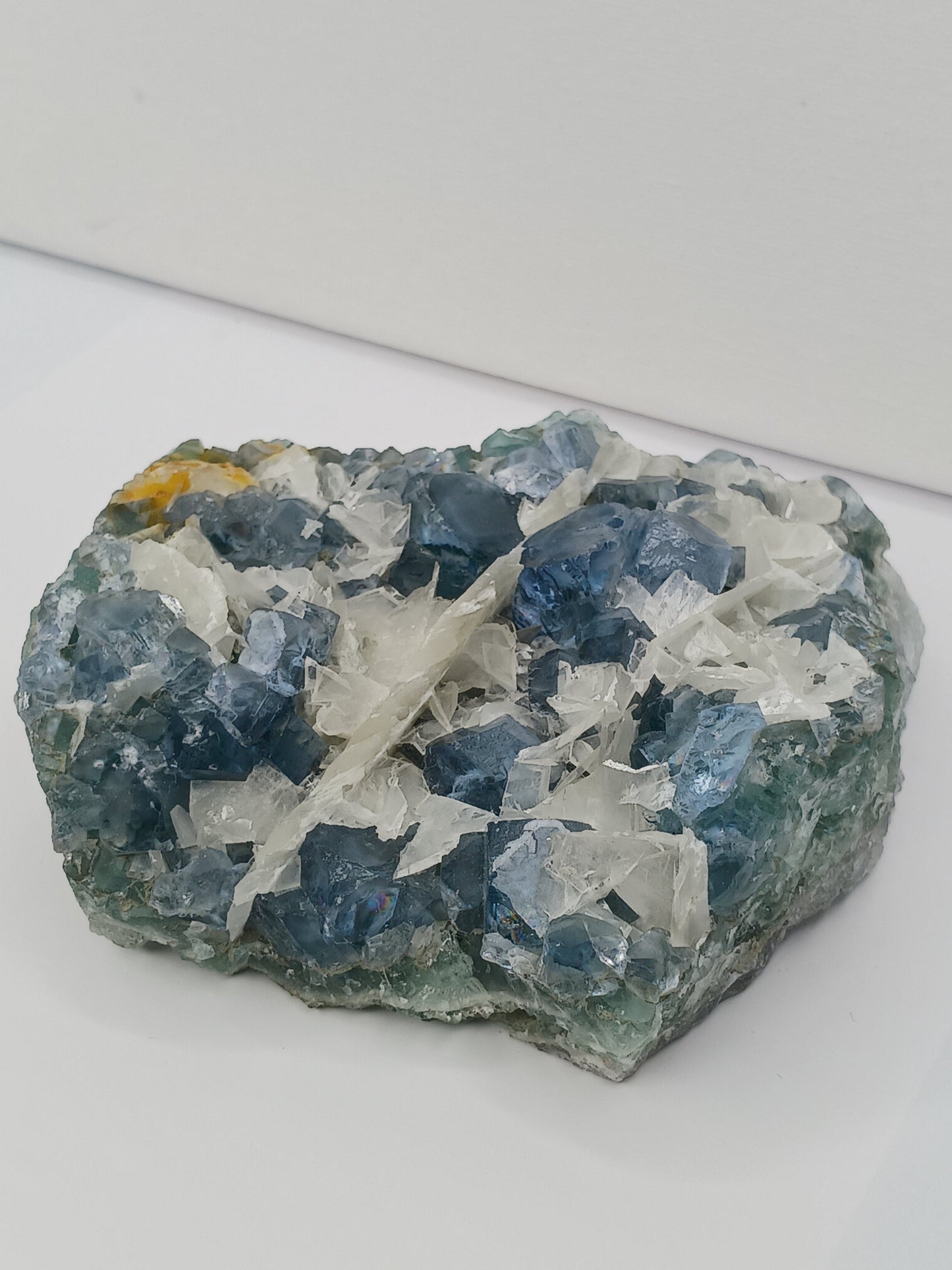 Sky blue fluorite with creamy calcite specimen, 4 x 5 inches, featuring unique blue and white patterns, displayed on a white background.
