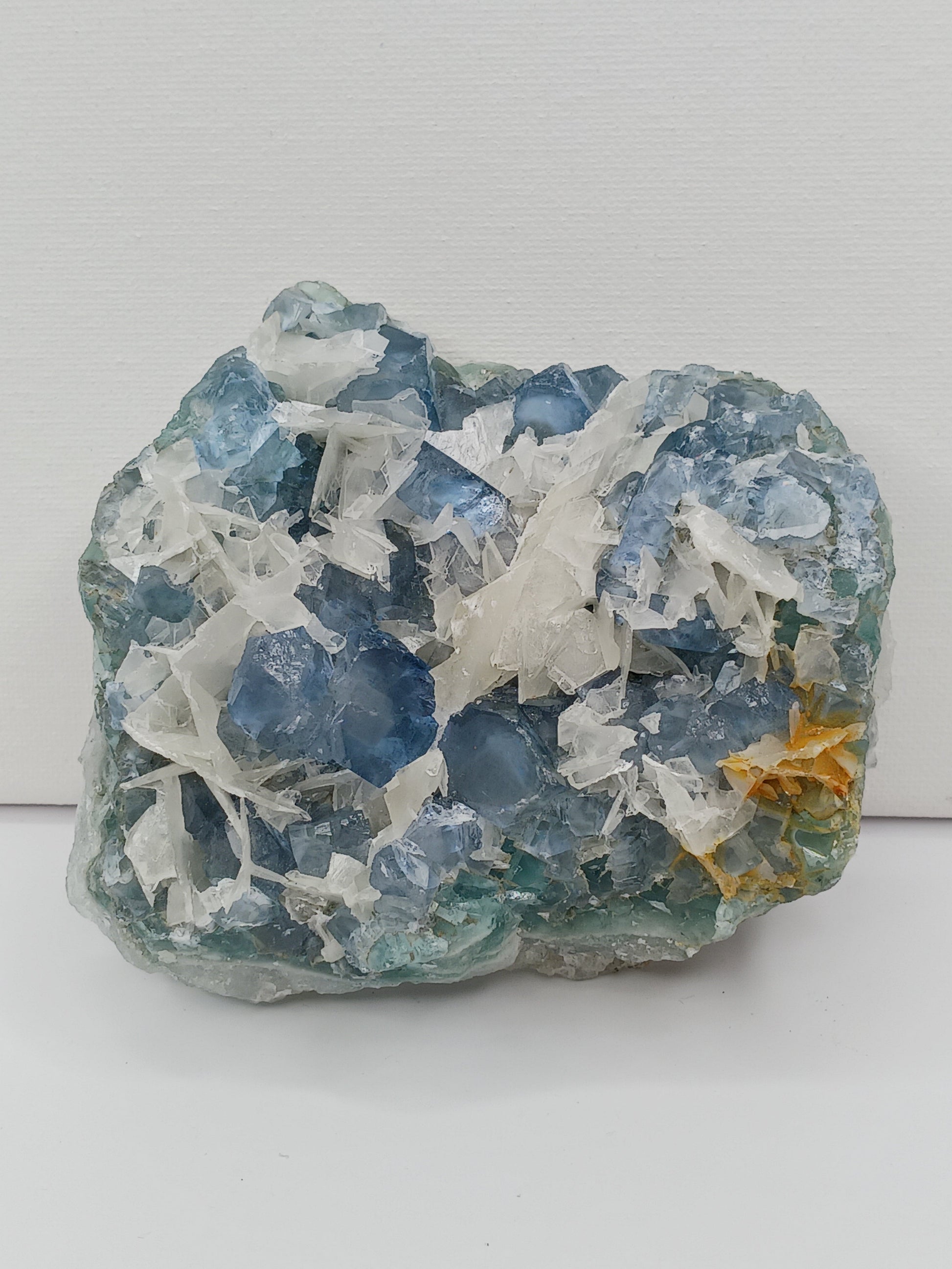 Sky blue fluorite with creamy calcite specimen, 4 x 5 inches, featuring unique blue and white patterns, displayed on a white background.