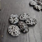 Hand-polished snowflake obsidian hearts and palmstones, featuring black stone with white snowflake patterns, displayed on a white background. Perfect for grounding, protection, and gentle transformation.