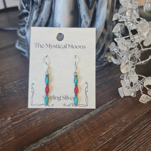 Sterling silver earrings with Southwest-inspired design featuring vibrant turquoise stones, displayed on a white background. Perfect for protection, wisdom, and desert magic.