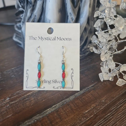 Sterling silver earrings with Southwest-inspired design featuring vibrant turquoise stones, displayed on a white background. Perfect for protection, wisdom, and desert magic.