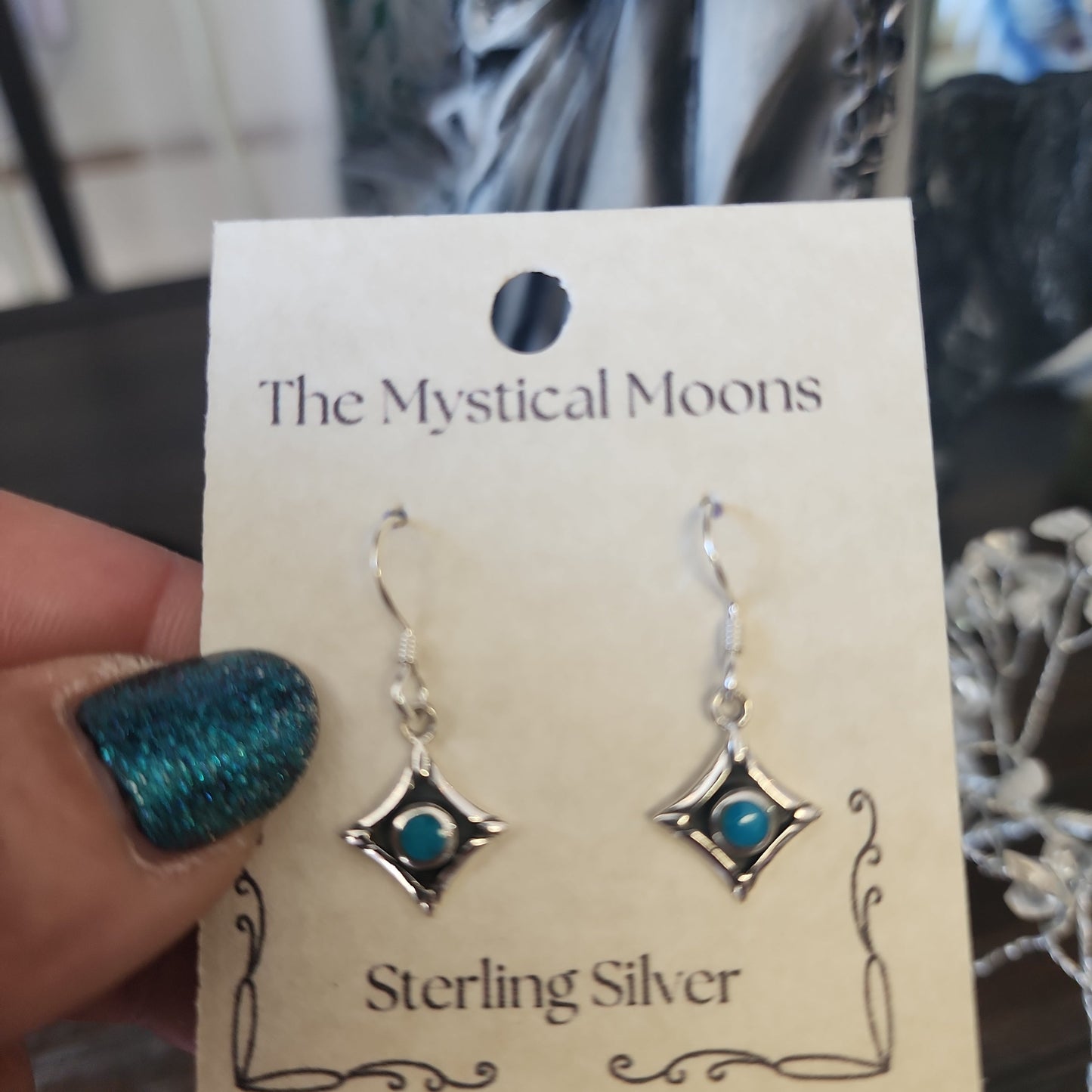 Sterling silver square earrings featuring vibrant turquoise stones, displayed on a white background. Perfect for protection, wisdom, and Southwestern style.