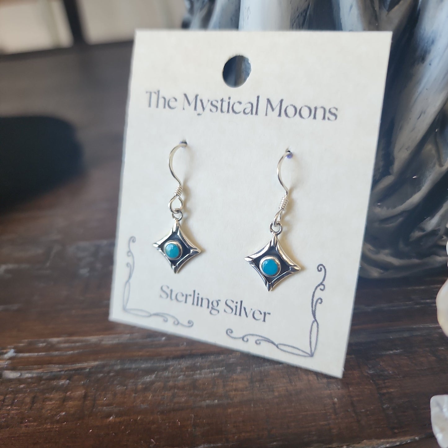 Sterling silver square earrings featuring vibrant turquoise stones, displayed on a white background. Perfect for protection, wisdom, and Southwestern style.