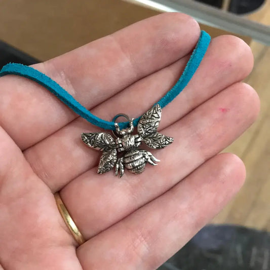 Sterling silver pendant featuring a detailed bumble bee, displayed on a white background. Perfect for joy, community, and personal power.