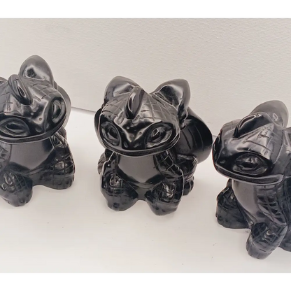 Toothless dragon carving, 3.5 inches, hand-carved from glossy black obsidian, displayed on a white background.