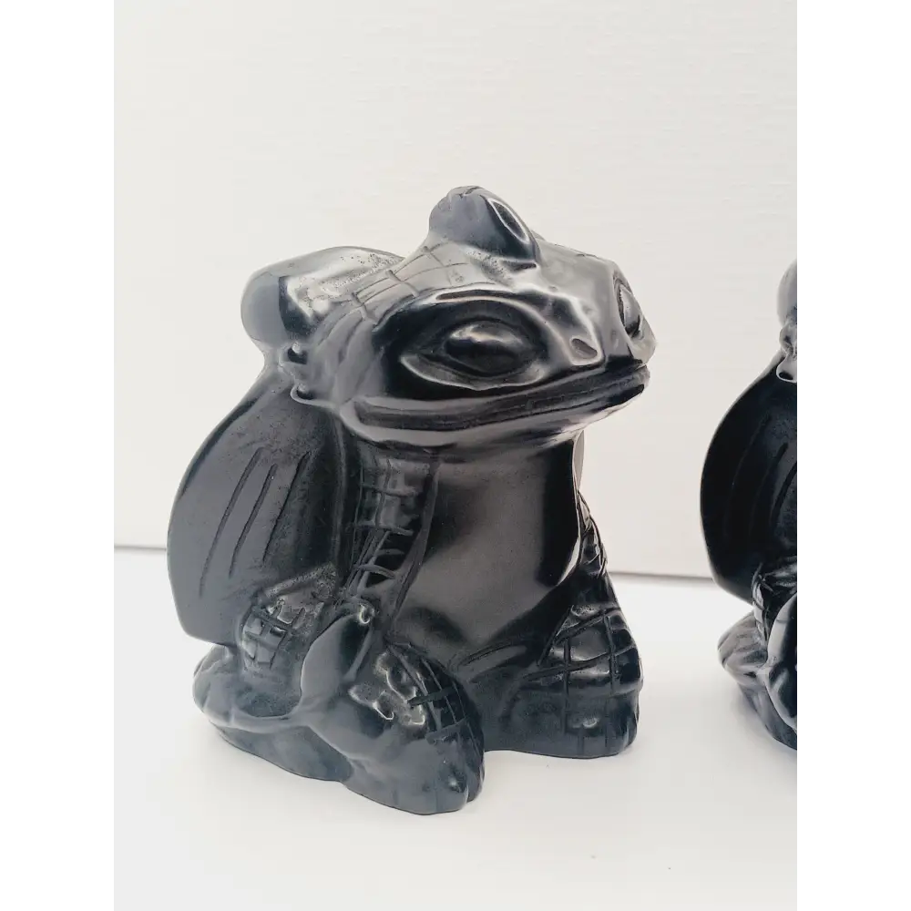 Toothless dragon carving, 3.5 inches, hand-carved from glossy black obsidian, displayed on a white background.
