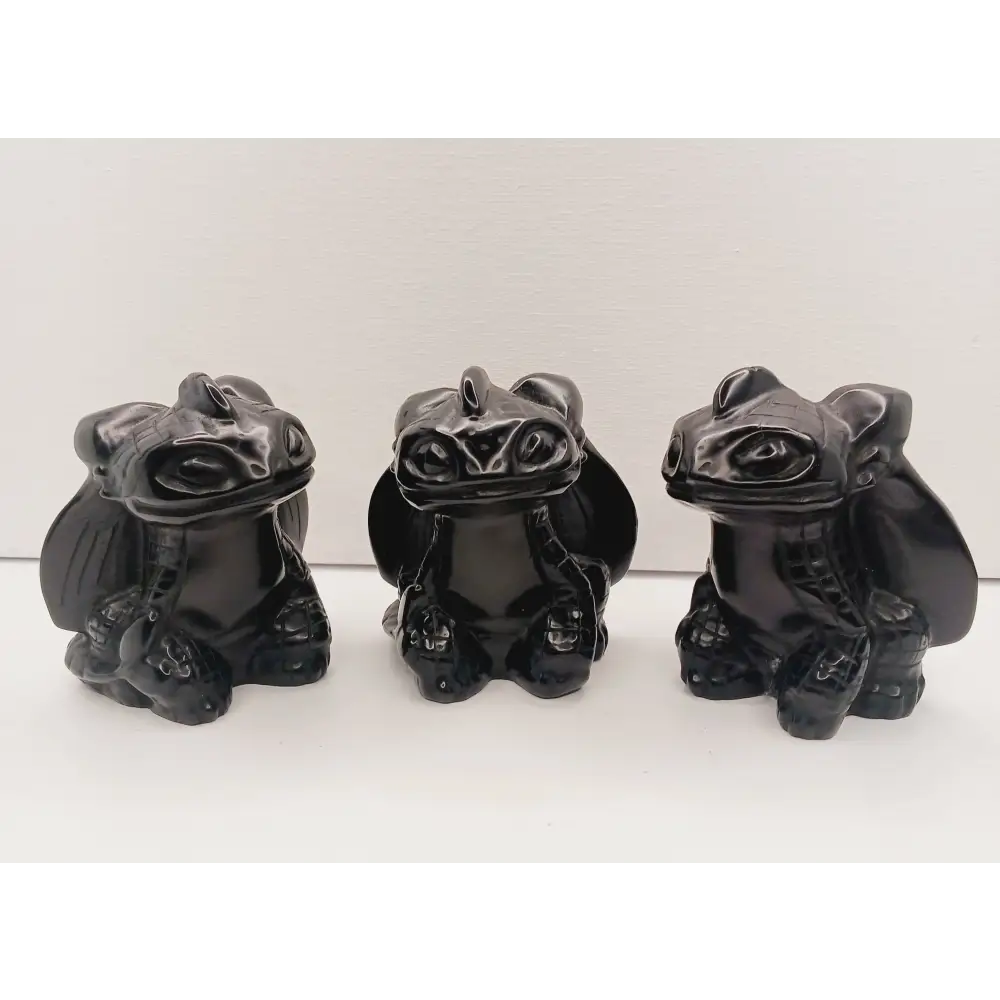 Toothless dragon carving, 3.5 inches, hand-carved from glossy black obsidian, displayed on a white background.