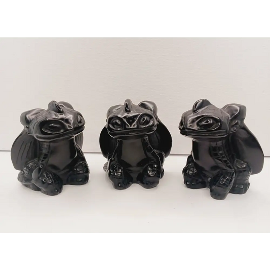 Toothless dragon carving, 3.5 inches, hand-carved from glossy black obsidian, displayed on a white background.
