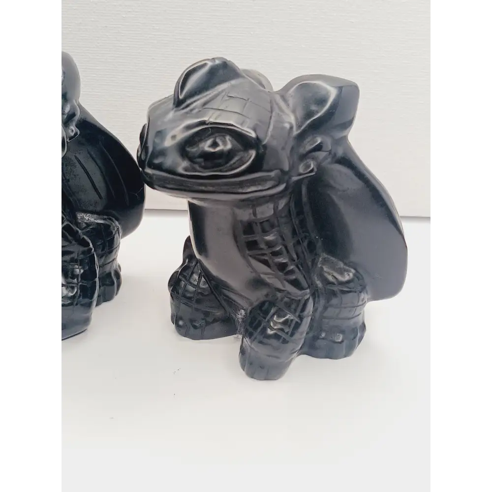 Toothless dragon carving, 3.5 inches, hand-carved from glossy black obsidian, displayed on a white background.