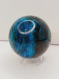 Turquoise sphere with vibrant blue-green color and natural veining, displayed on a white background.