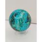 Turquoise sphere with vibrant blue-green color and natural veining, displayed on a white background.