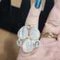 Assorted sterling silver rings featuring unique genuine gemstones in various shapes and colors, displayed on a white background. Perfect for crystal energy, personal style, and one-of-a-kind magic.