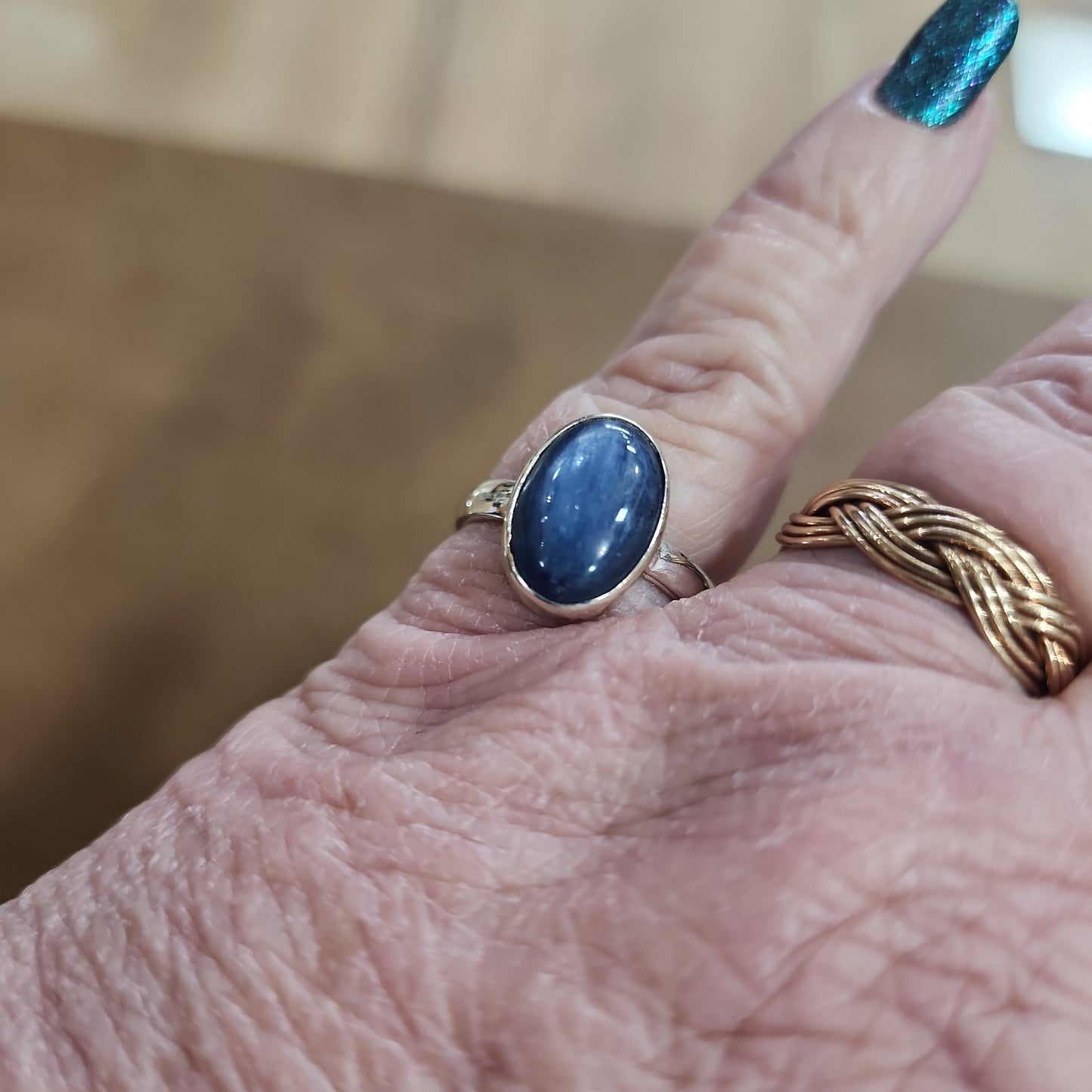 Assorted sterling silver rings featuring unique genuine gemstones in various shapes and colors, displayed on a white background. Perfect for crystal energy, personal style, and one-of-a-kind magic.
