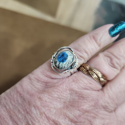 Assorted sterling silver rings featuring unique genuine gemstones in various shapes and colors, displayed on a white background. Perfect for crystal energy, personal style, and one-of-a-kind magic.