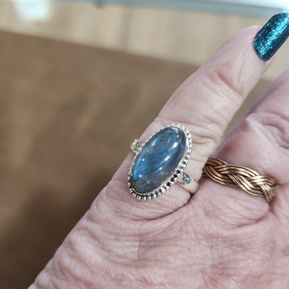 Assorted sterling silver rings featuring unique genuine gemstones in various shapes and colors, displayed on a white background. Perfect for crystal energy, personal style, and one-of-a-kind magic.