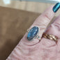 Assorted sterling silver rings featuring unique genuine gemstones in various shapes and colors, displayed on a white background. Perfect for crystal energy, personal style, and one-of-a-kind magic.