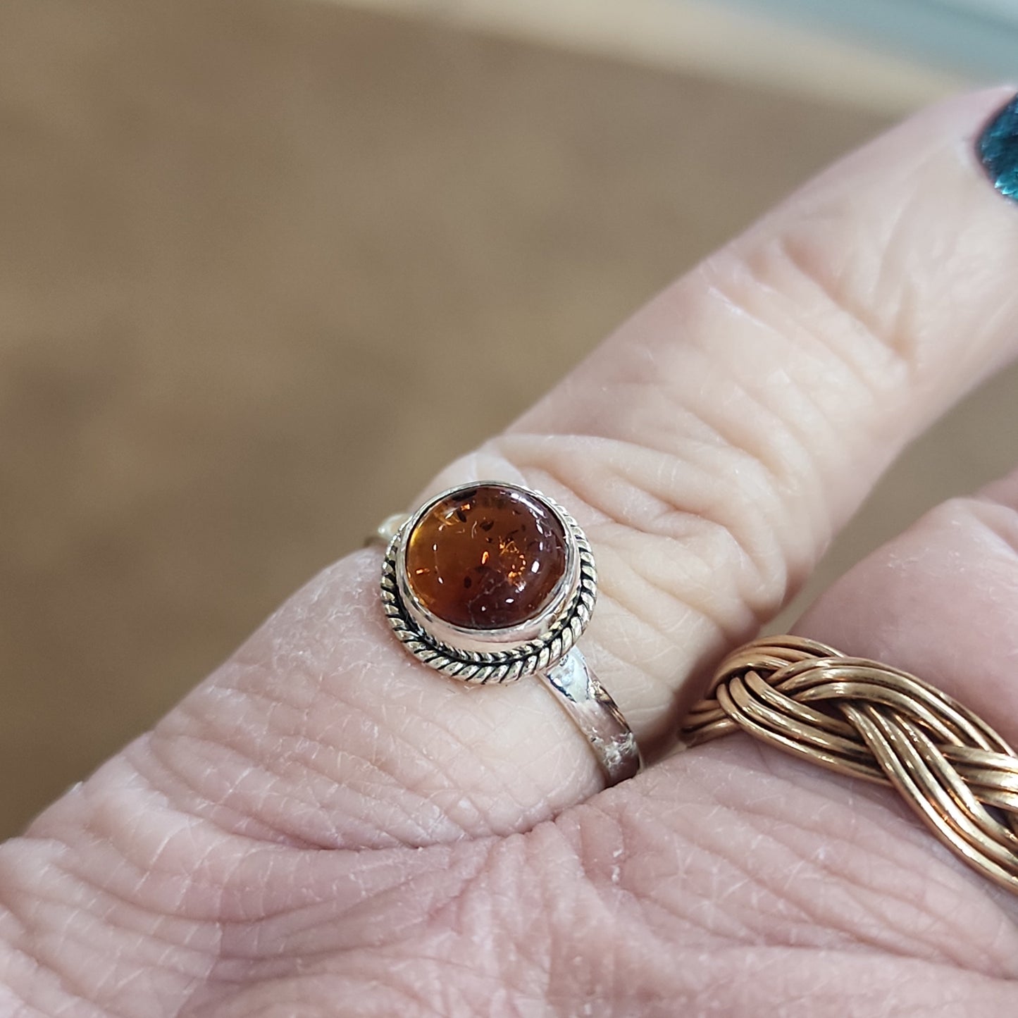 Assorted sterling silver rings featuring unique genuine gemstones in various shapes and colors, displayed on a white background. Perfect for crystal energy, personal style, and one-of-a-kind magic.