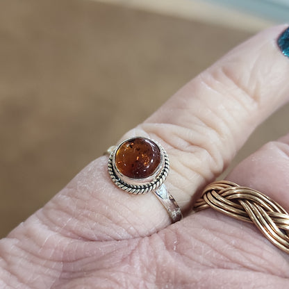 Assorted sterling silver rings featuring unique genuine gemstones in various shapes and colors, displayed on a white background. Perfect for crystal energy, personal style, and one-of-a-kind magic.