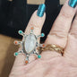 Assorted sterling silver rings featuring unique genuine gemstones in various shapes and colors, displayed on a white background. Perfect for crystal energy, personal style, and one-of-a-kind magic.