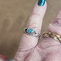 Assorted sterling silver rings featuring unique genuine gemstones in various shapes and colors, displayed on a white background. Perfect for crystal energy, personal style, and one-of-a-kind magic.