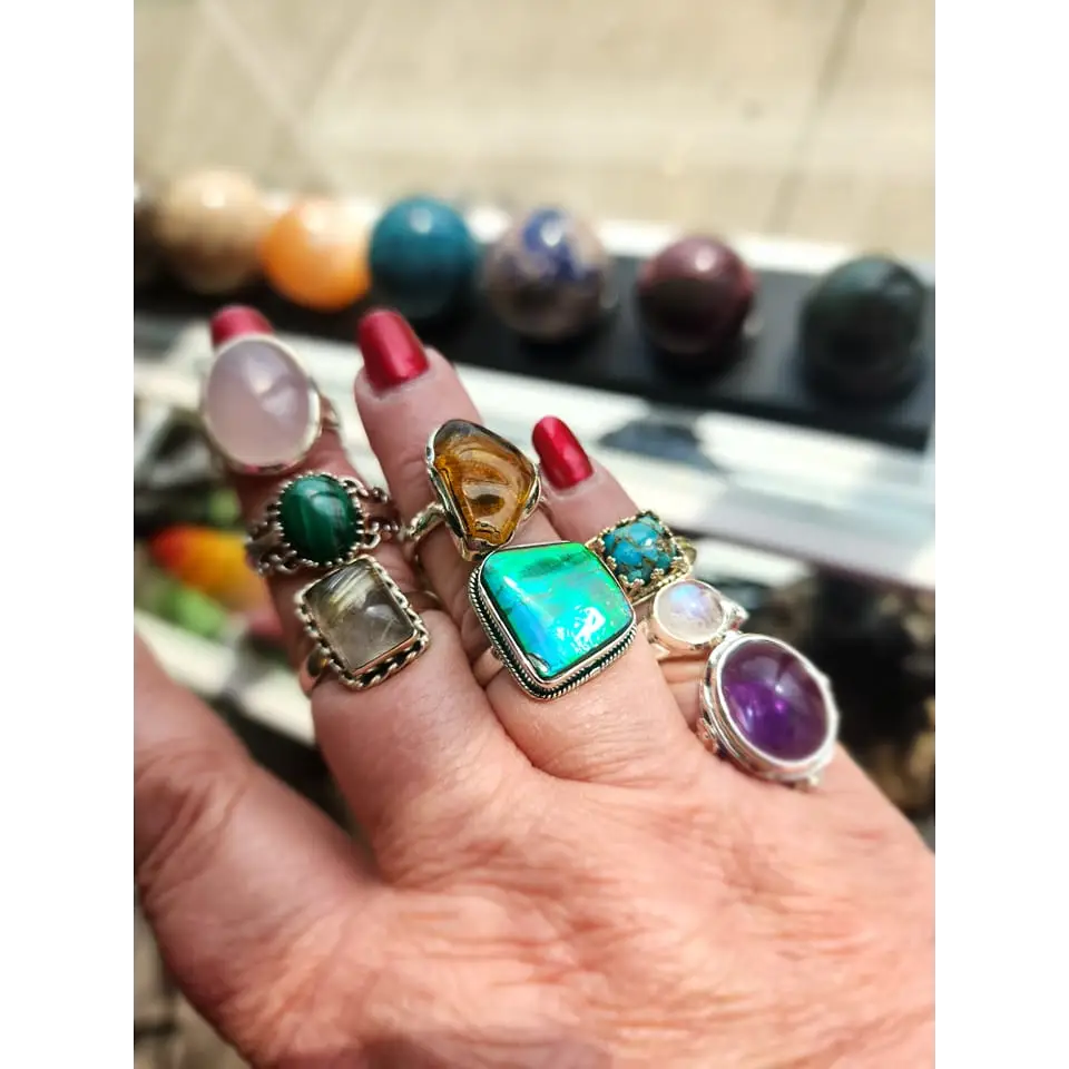 Assorted sterling silver rings featuring unique genuine gemstones in various shapes and colors, displayed on a white background. Perfect for crystal energy, personal style, and one-of-a-kind magic.

