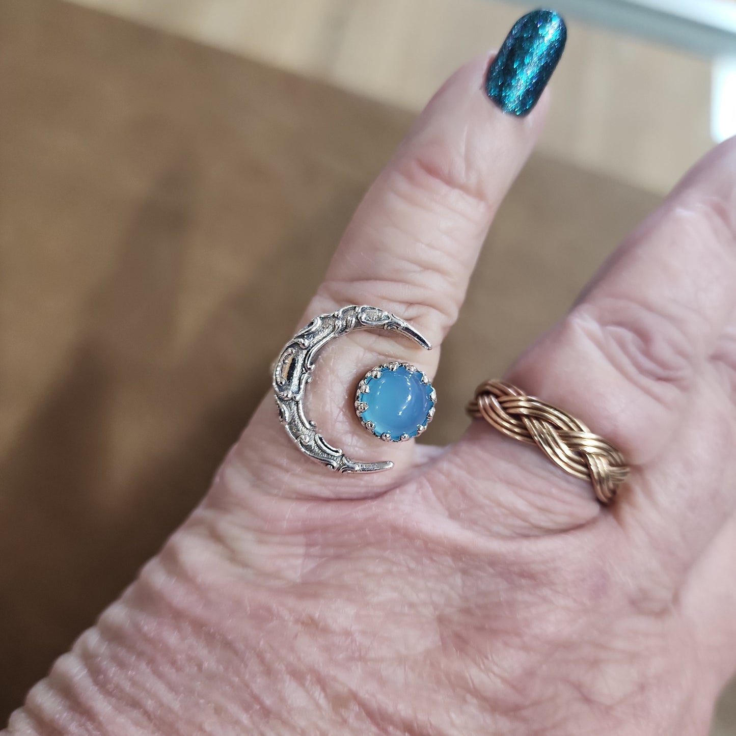 Assorted sterling silver rings featuring unique genuine gemstones in various shapes and colors, displayed on a white background. Perfect for crystal energy, personal style, and one-of-a-kind magic.